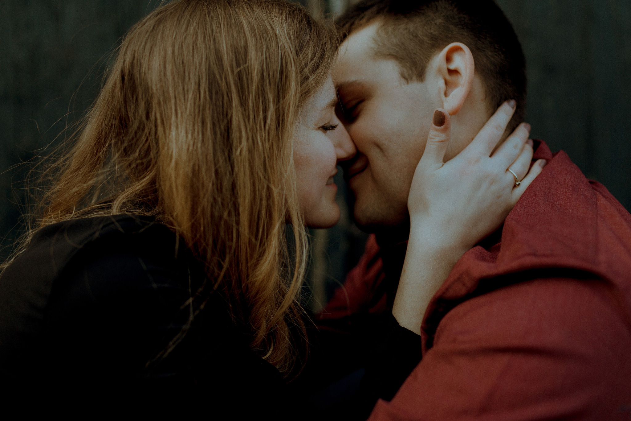 cozy couple kissing romantically while smiling