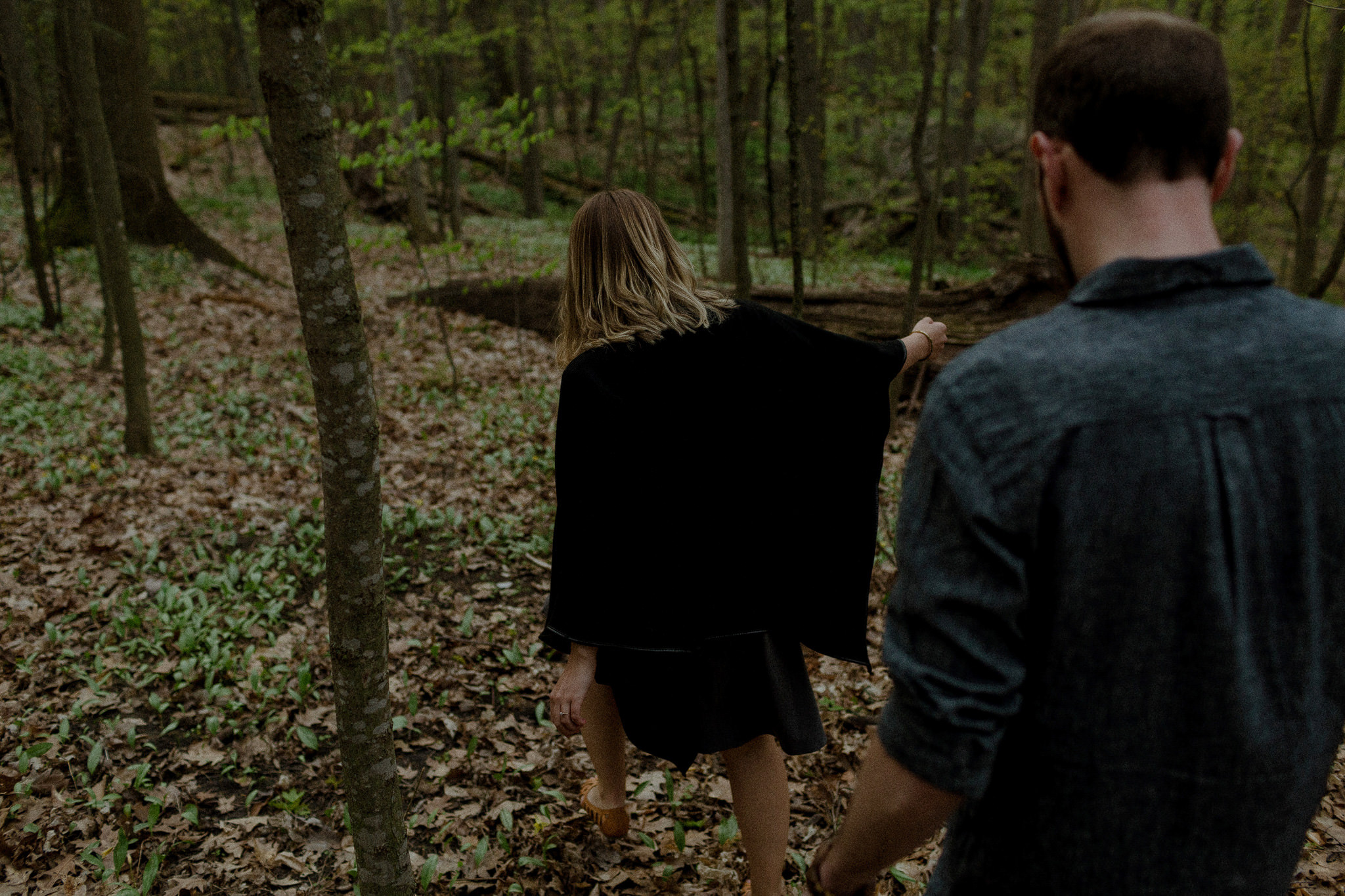 Couple hiking through woods, different engagement photoshoot