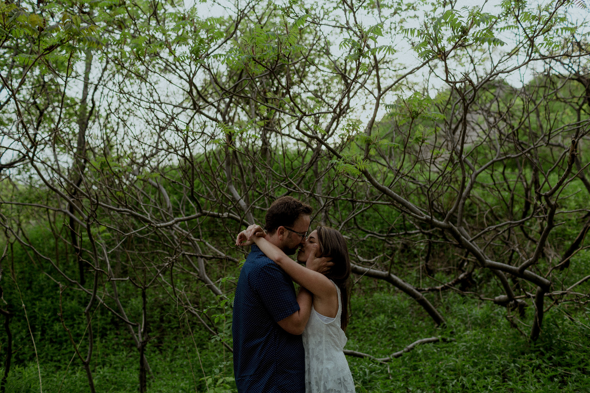 Engaged couple kissing at Evergreen Brickworks
