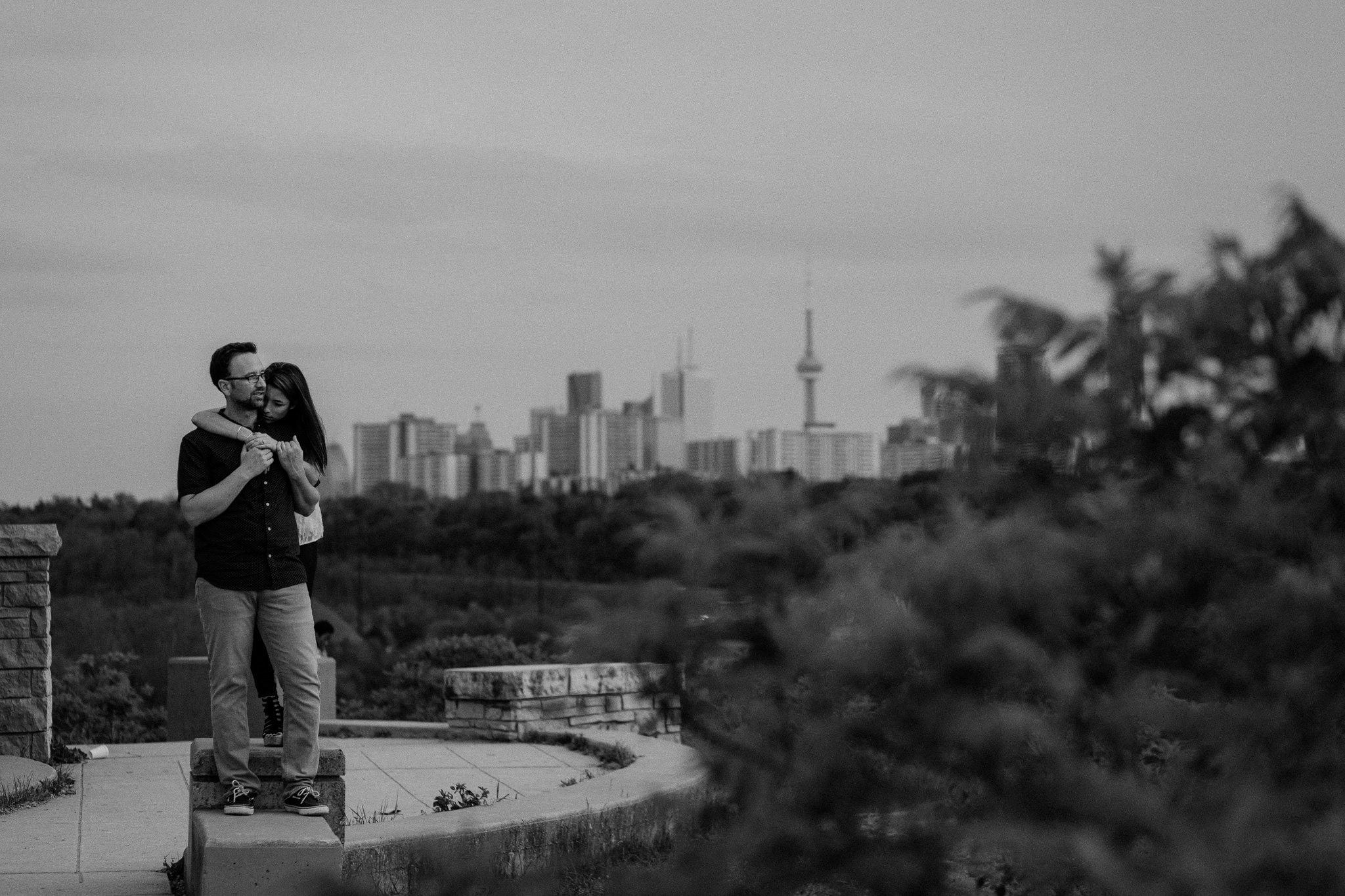 Engagement couple against toronto skyline at Evergreen Brickworks
